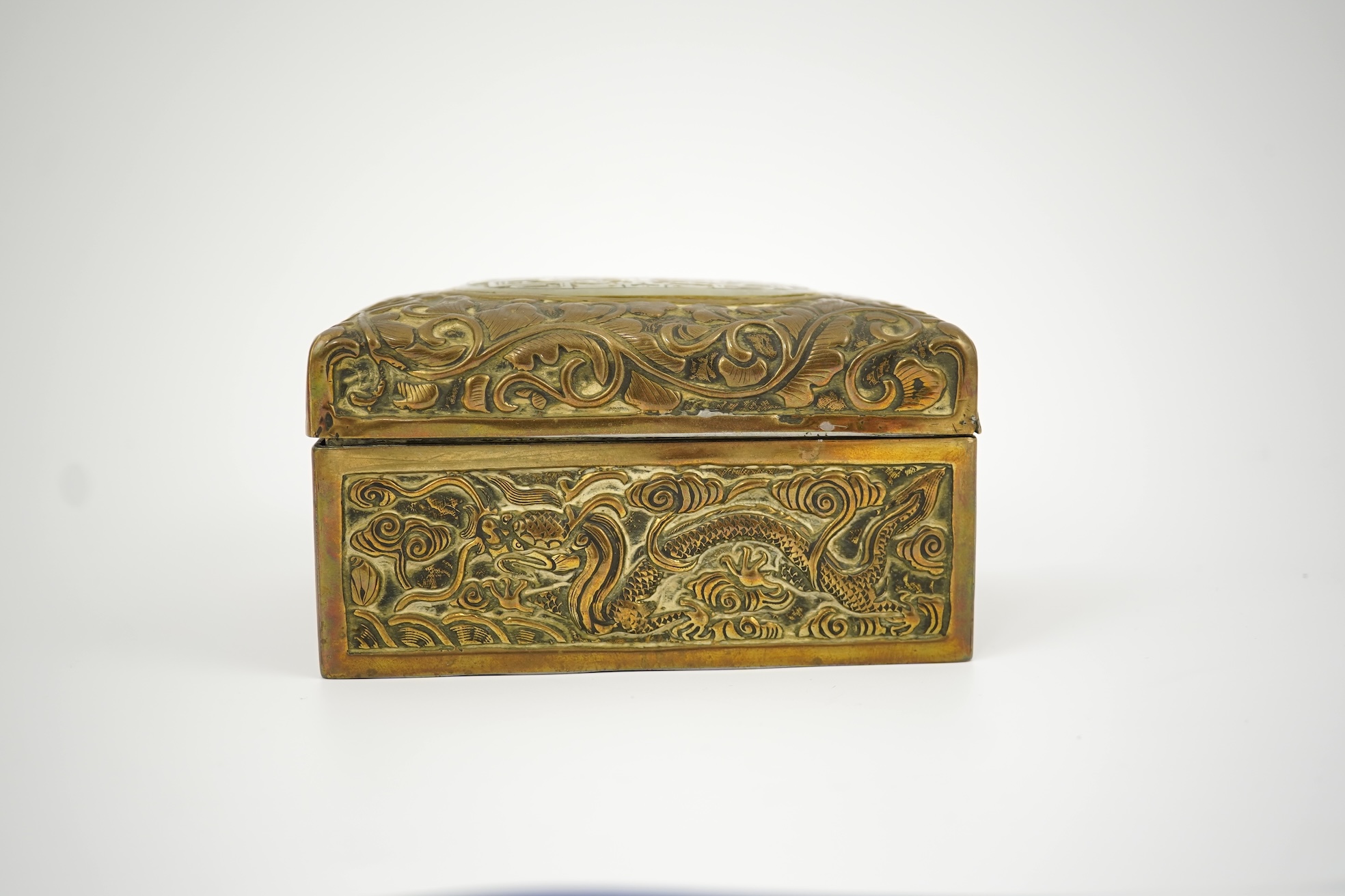 A Chinese brass 'dragon' box, inset with a 17th/18th century jade plaque